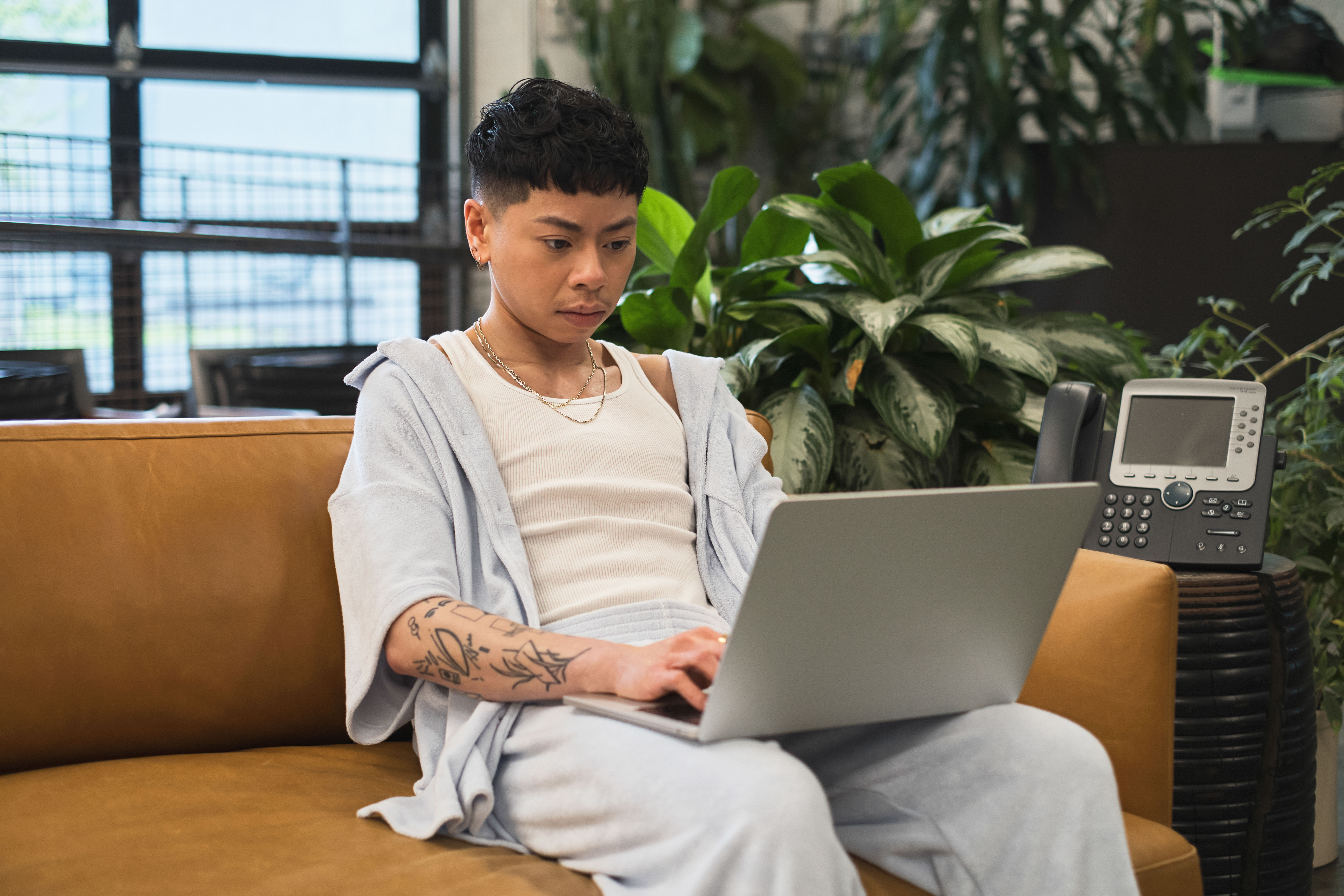 A non-binary person using a laptop (4)